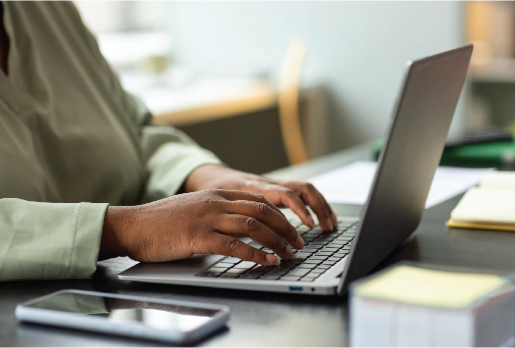 Person writing a health blog on a laptop